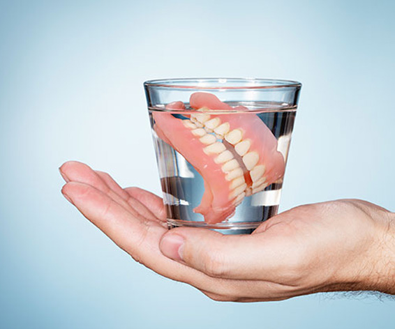 dentures inside the glass of water 